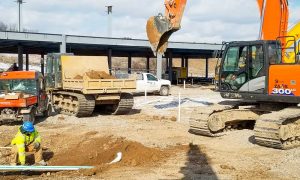WhiteCap Construction Site in Summer with Backhoes and Workers